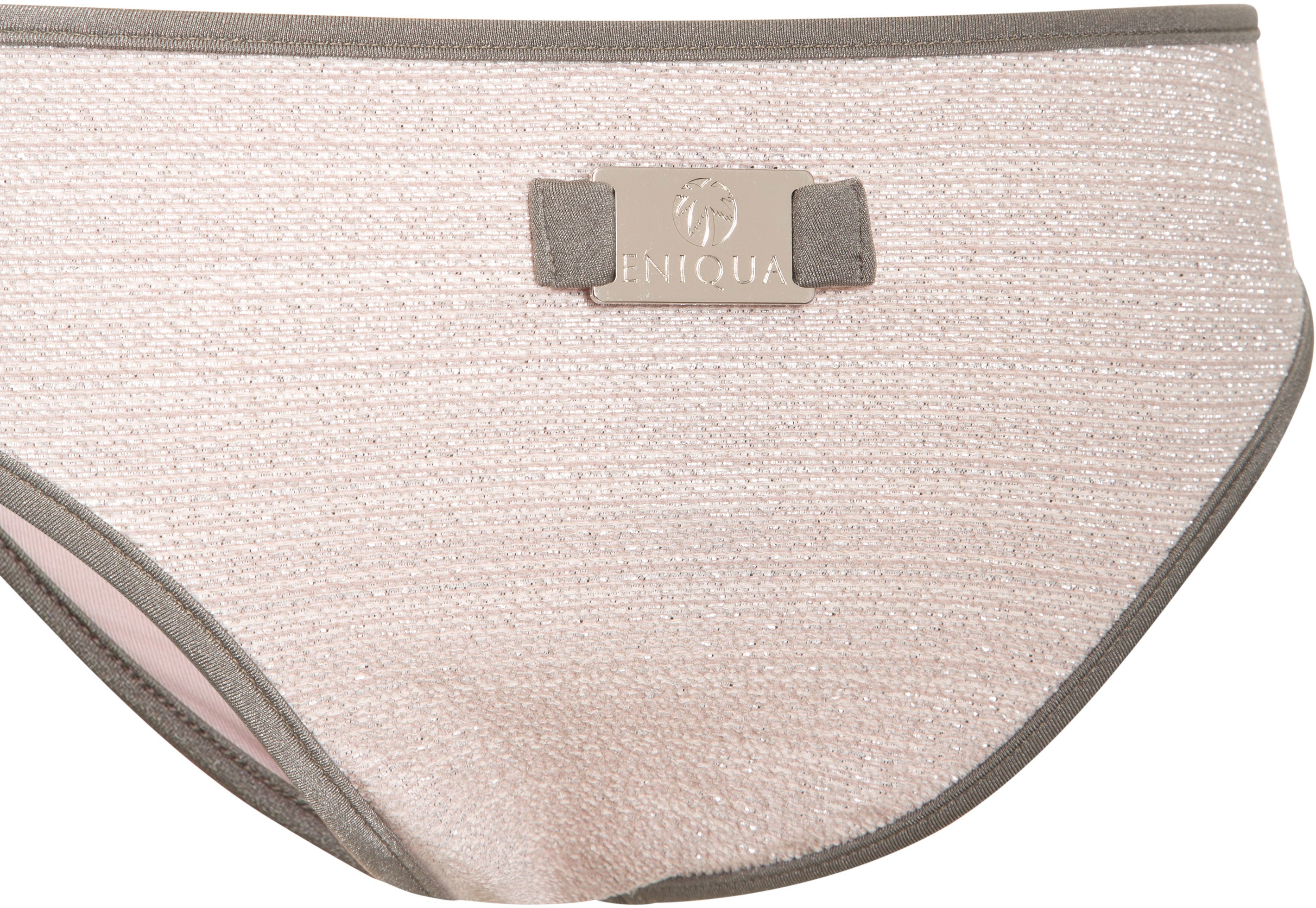 Close-up of a light pink bikini bottom by Eniqua with grey trim, made in Italy and featuring a metallic brand logo plaque on the waistband.
